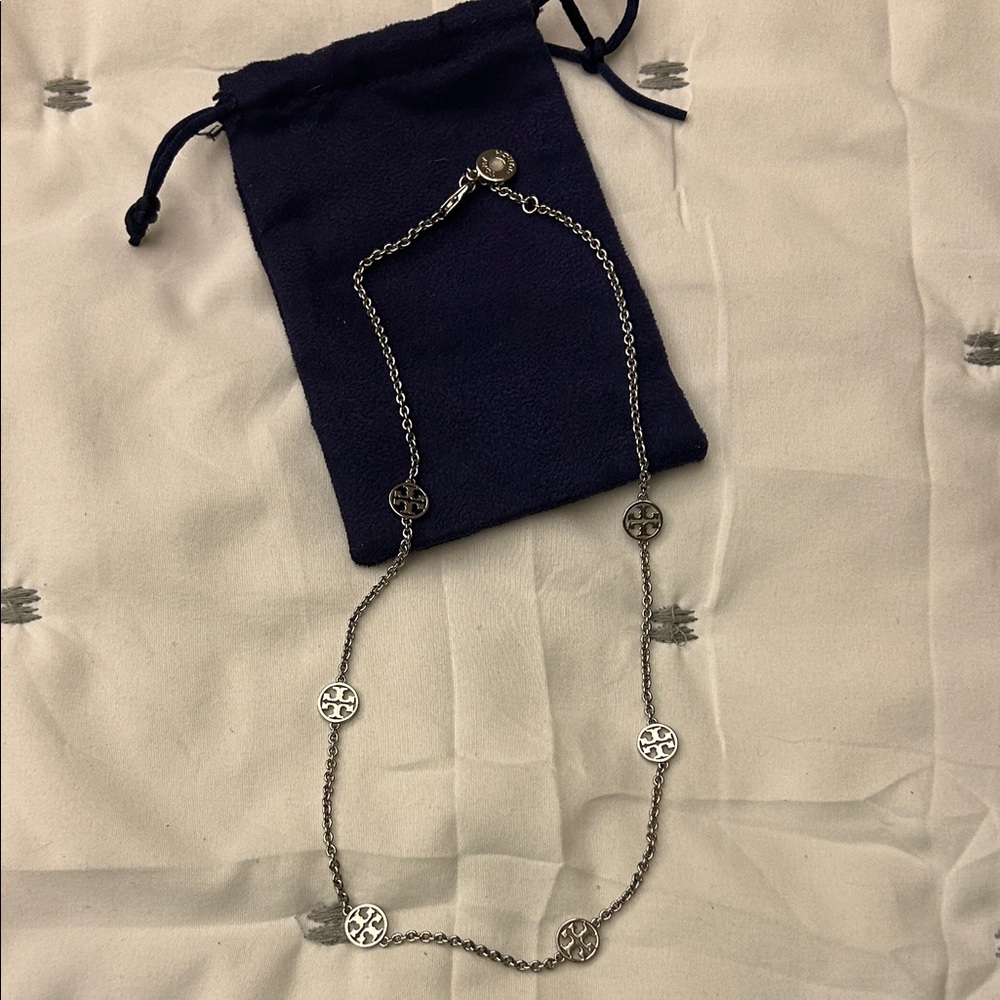 Tory Burch silver logo necklace.